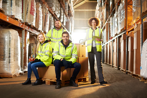 a warehouse team pose for a group shot